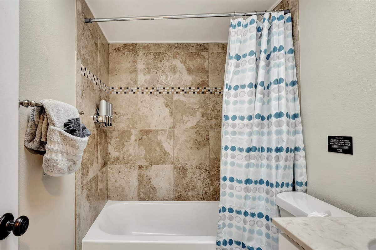 Immerse yourself in the serenity of a rejuvenating shower in our modern walk-in shower, surrounded by beautiful white clean-finish interiors.