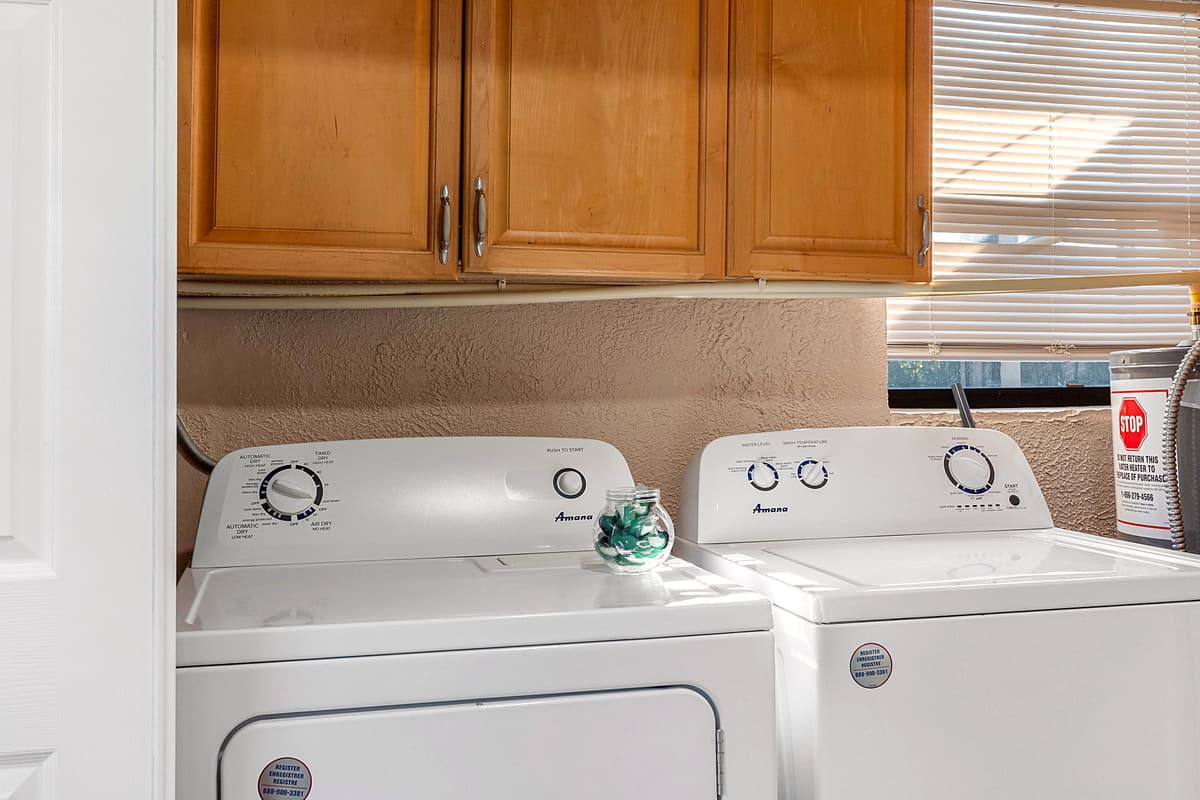 This home includes a full laundry area complete with a washer, dryer, and essential laundry supplies.