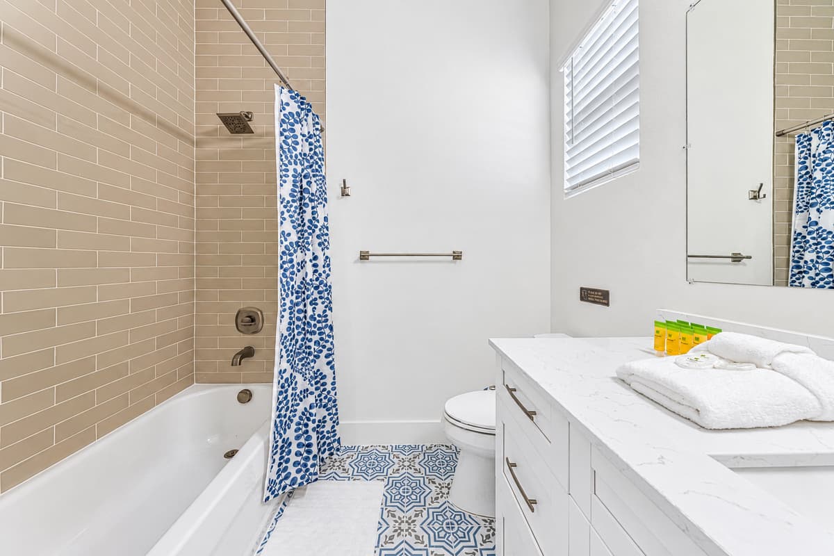 Bathroom 2 (en suite): tub/shower combination with modern fixtures.