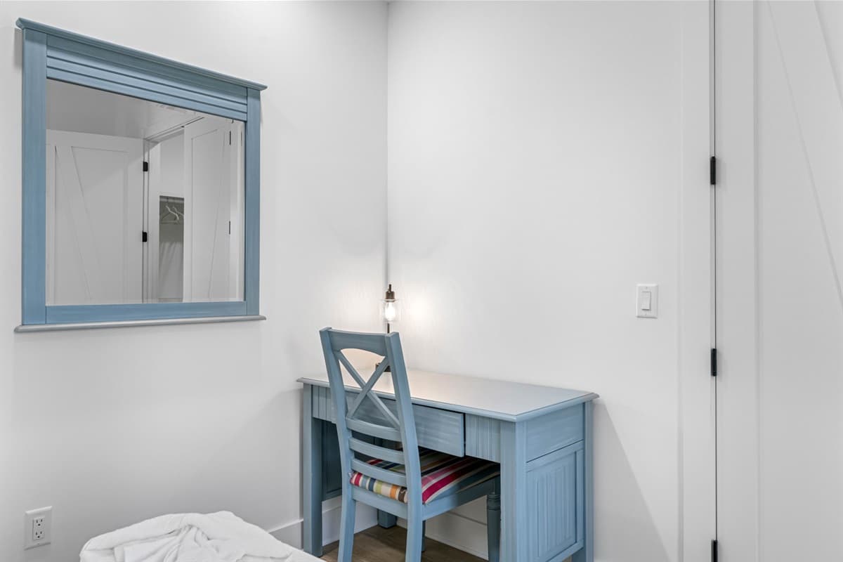 In addition to the comfortable sleeping arrangements, this twin bedroom features a dedicated study or work desk, thoughtfully positioned to maximize space and functionality.