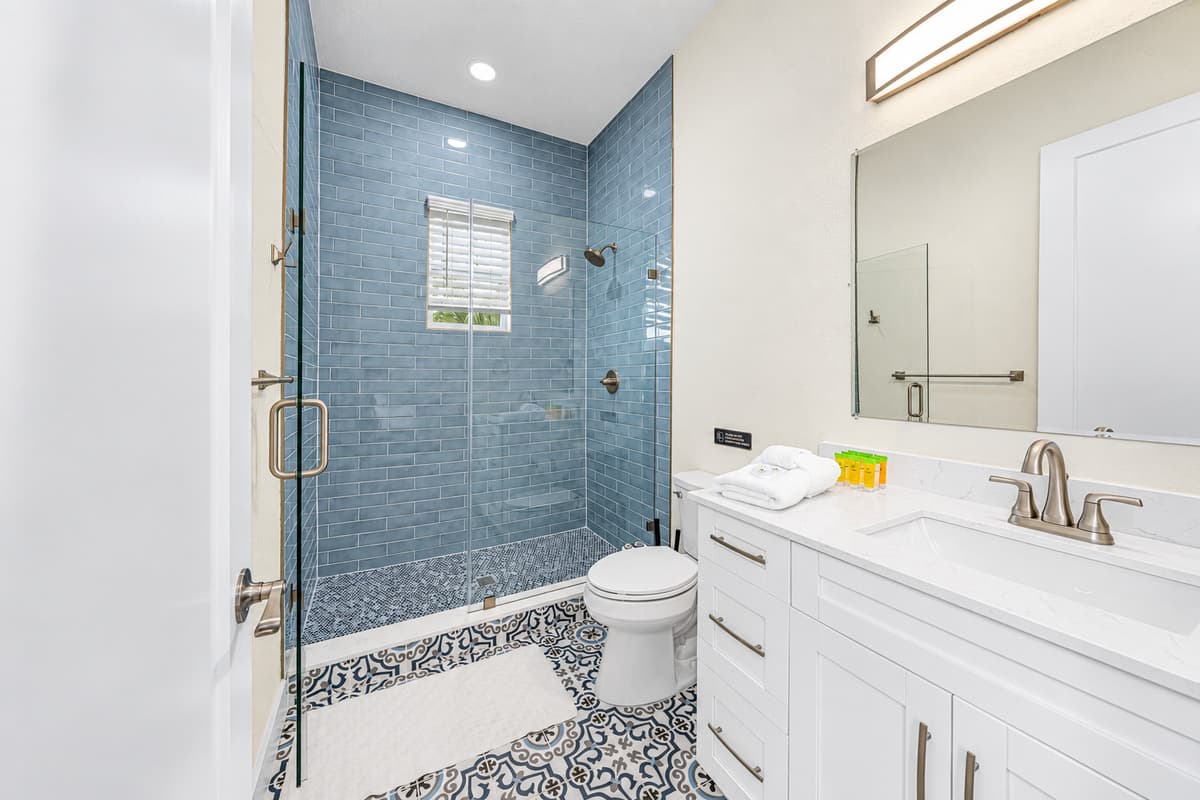 Stylish bathroom with glass walk-in shower and contemporary design.