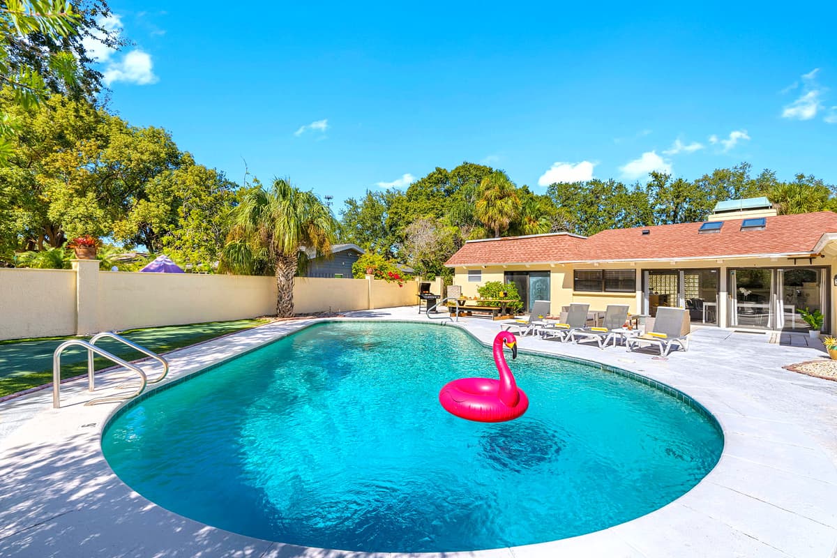 With lush landscaping, comfortable seating, and a crystal-clear pool, this outdoor space brings together relaxation and beauty in one spot.