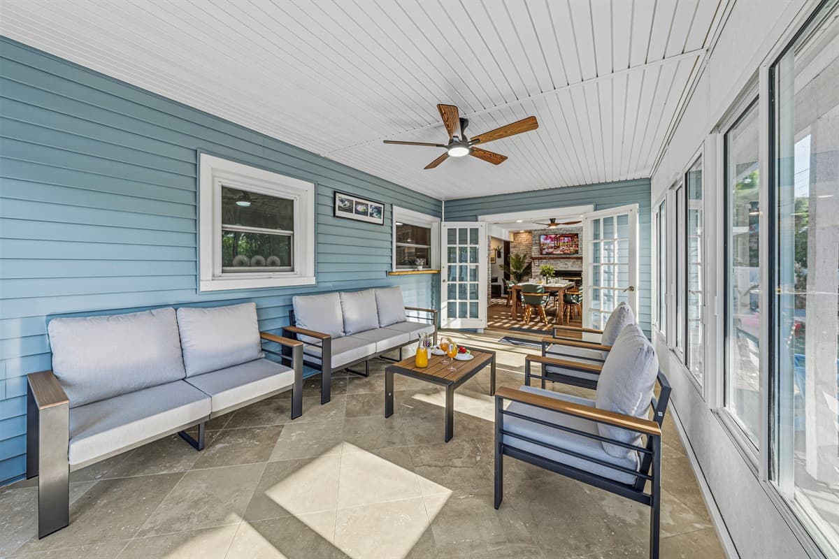 Beautiful screened-in patio with comfortable seating and ceiling fan—great for year-round enjoyment 