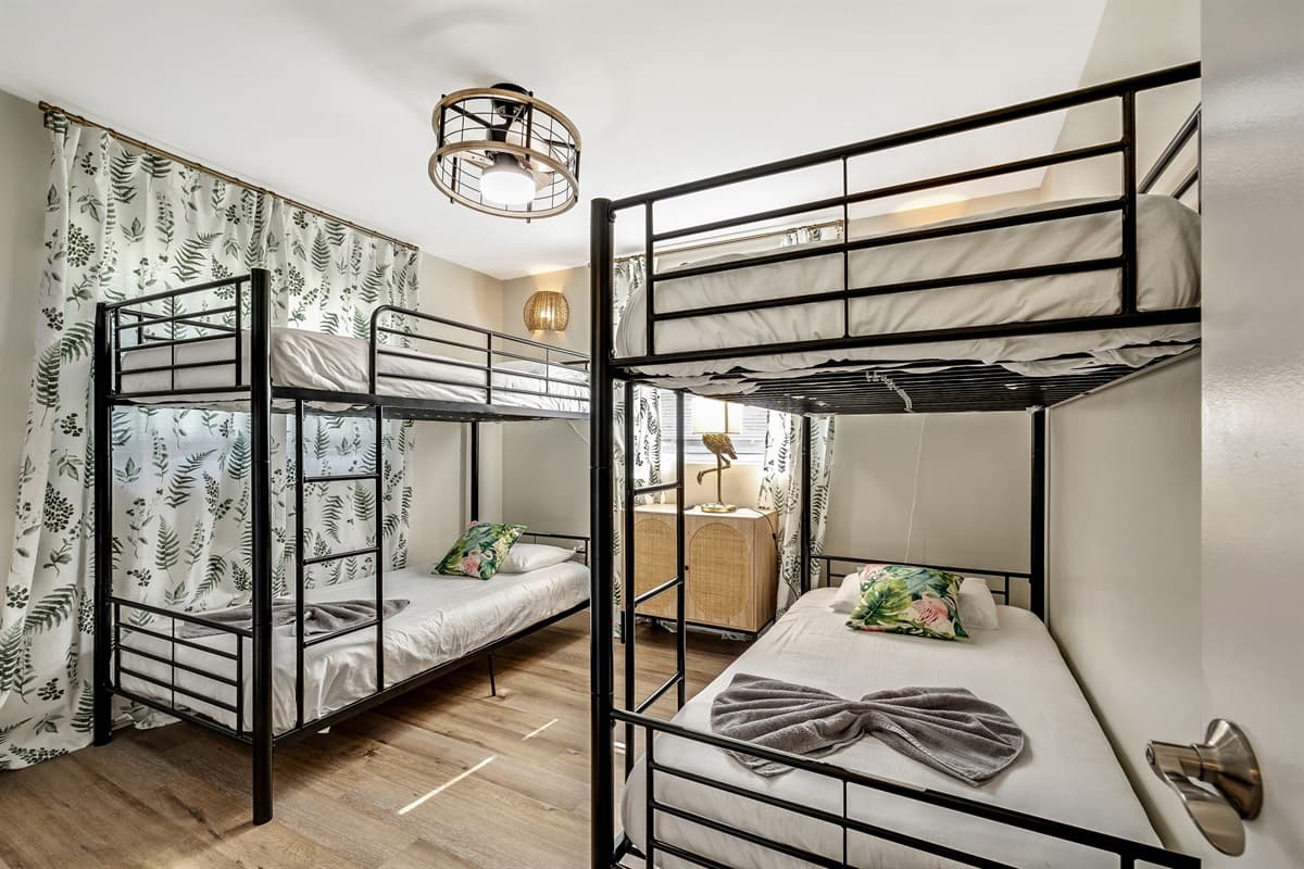 This inviting room is adorned with two bunk beds, offering ample space for rest and relaxation in a cozy and welcoming atmosphere.
