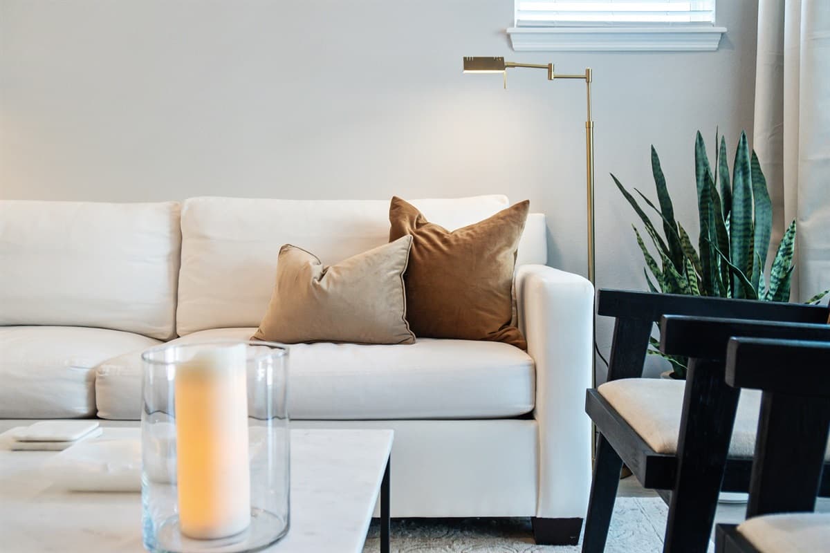 Your gaze drifts across the spacious lounge, taking in the carefully curated selection of plush furnishings arranged with impeccable taste.
