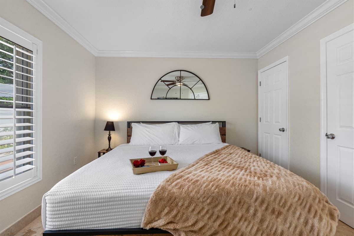 The wood-accented bed frame and earthy throw add rustic charm to this otherwise sleek and modern bedroom.
