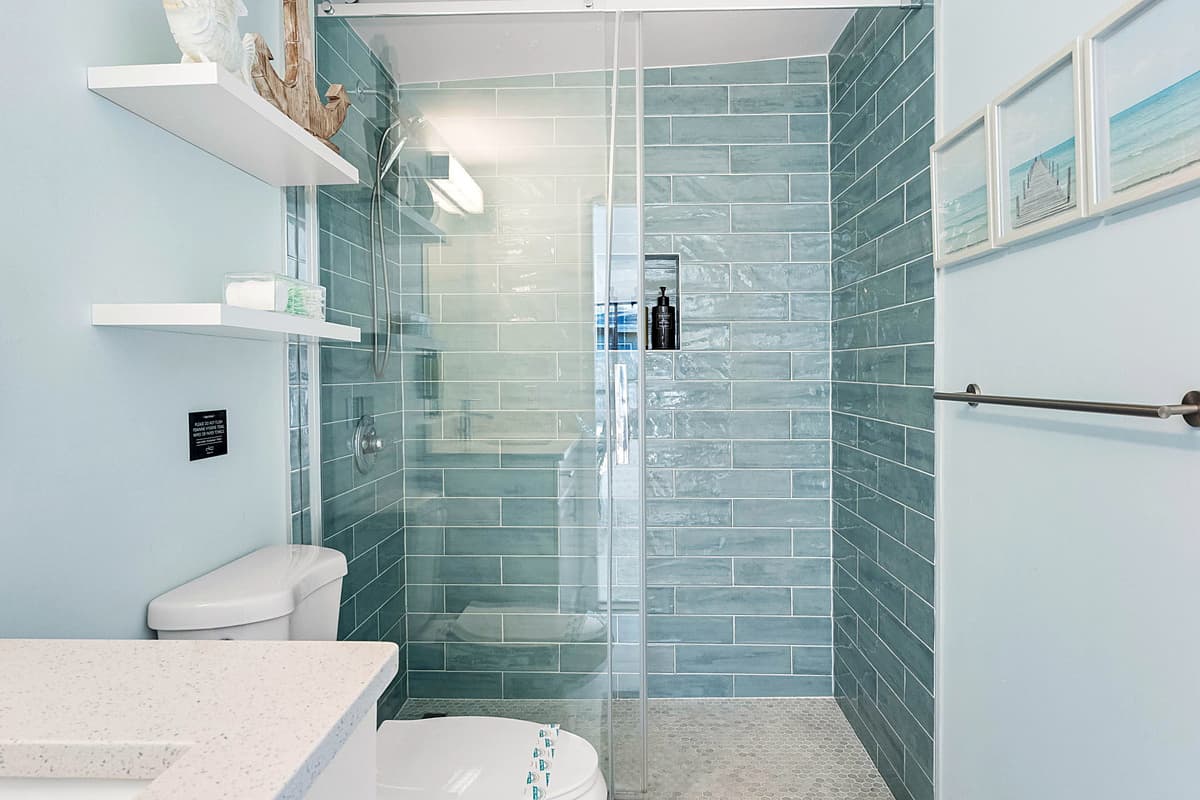 This modern bathroom boasts an enclosed walk-in shower, providing a sleek and spacious option for your daily routine.