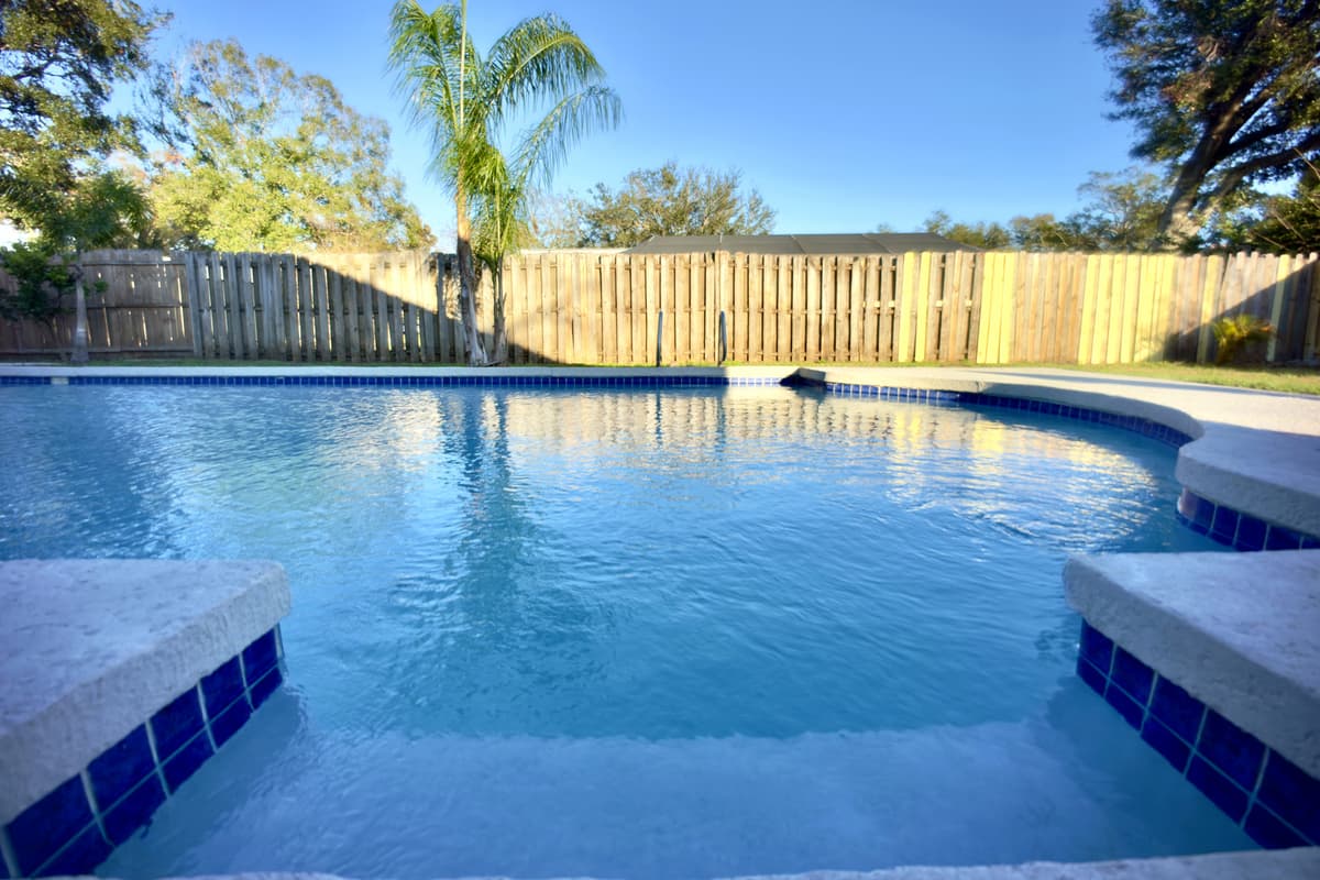 Unwind in a serene outdoor space featuring a shimmering private pool, perfect for a relaxing swim or soaking up the sunshine.