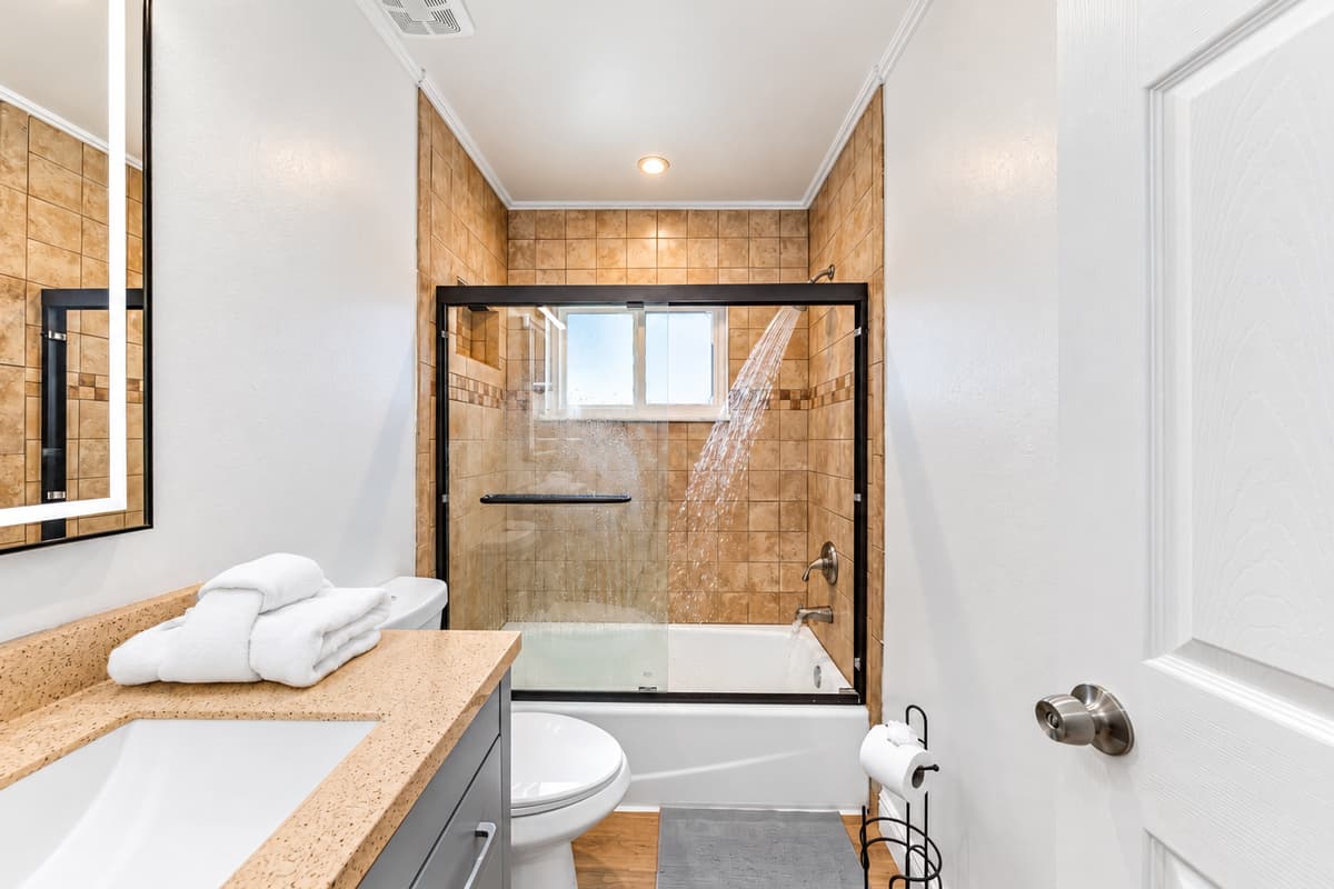 With a shower/tub combo and plenty of counter space, this bathroom works perfectly for families or groups.