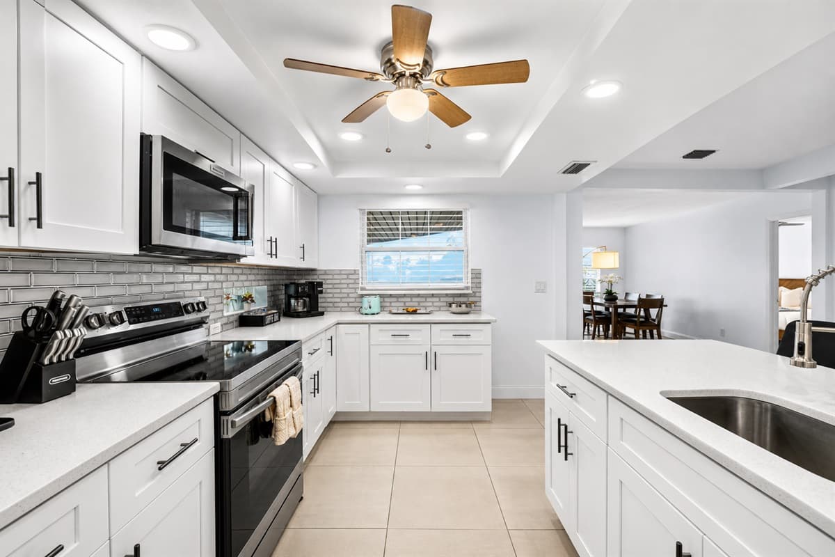 Bright and stylish kitchen with modern appliances, generous counter space, and breakfast seating.