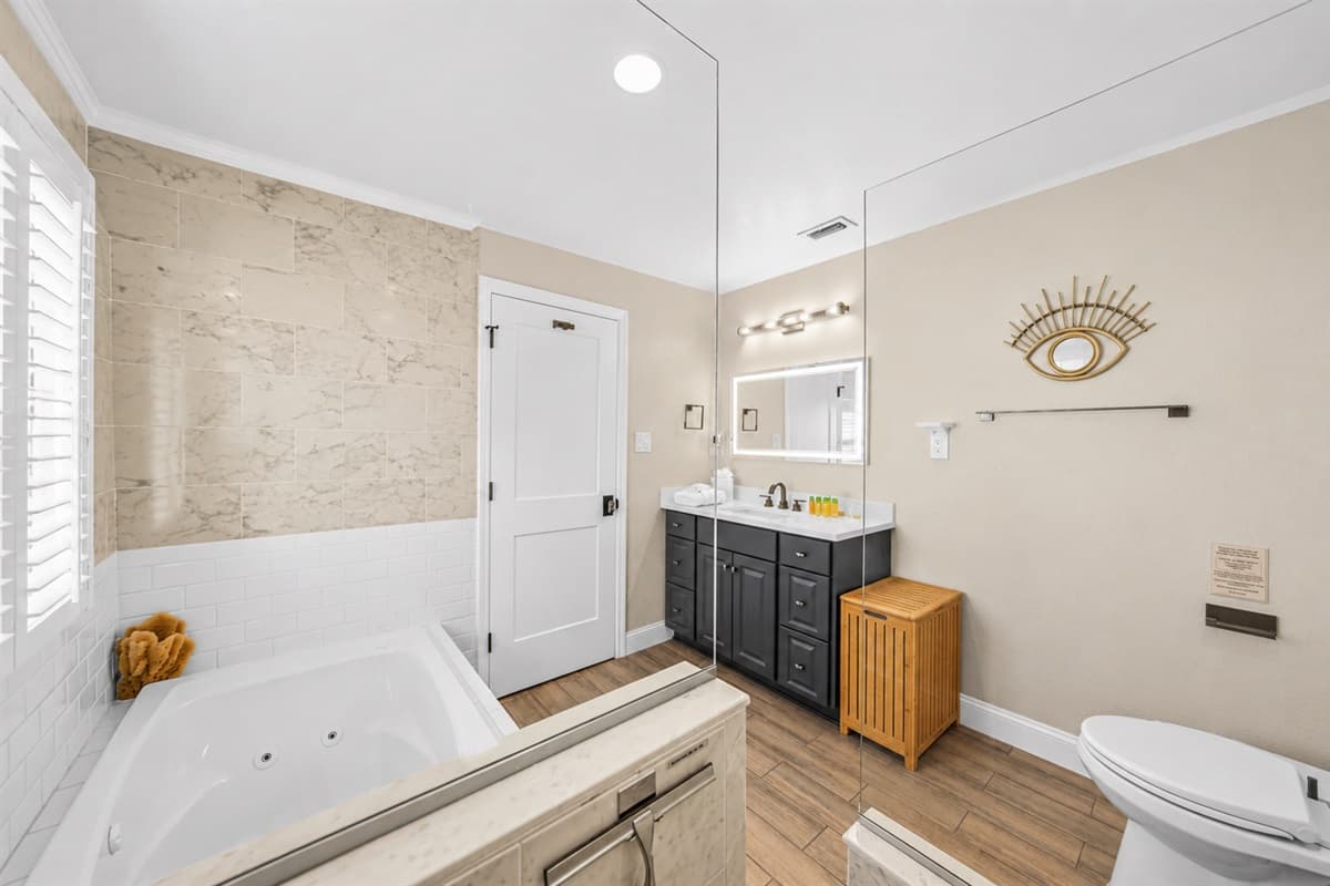 Spacious luxury bathroom with soaking tub, walk-in shower, double vanity, and modern spa-like design.
