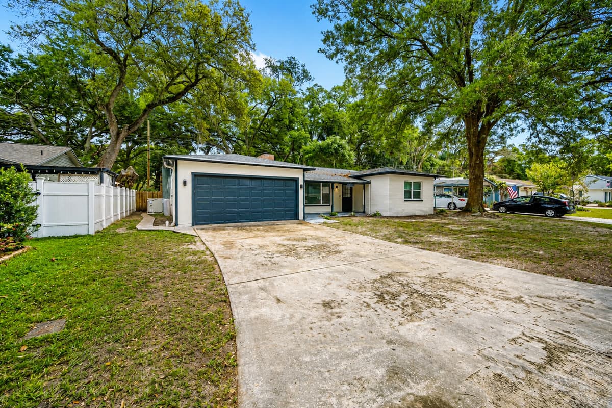 The left side area of the house showcasing the driveway to the garage. Never worry about where to park your cars. Don't hesitate to send us a message!