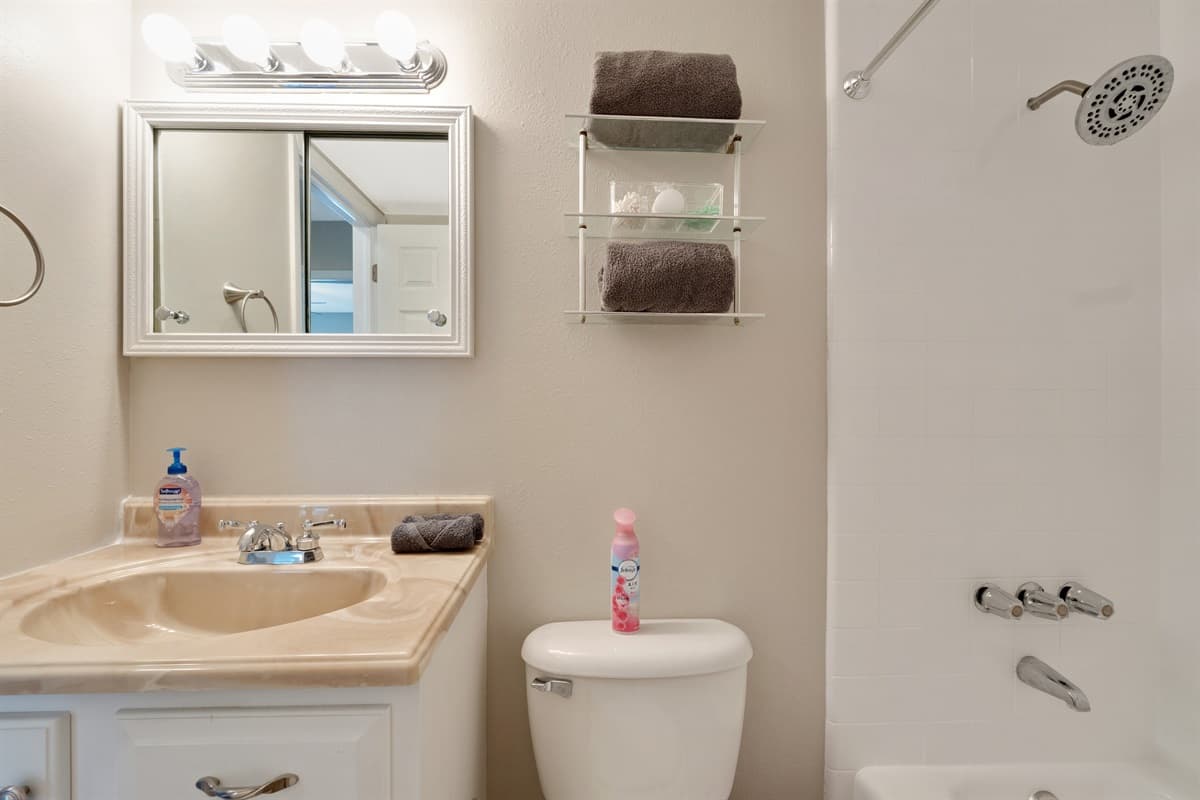 This bathroom is adorned with elegant tiles that complement the contemporary fixtures and fittings.