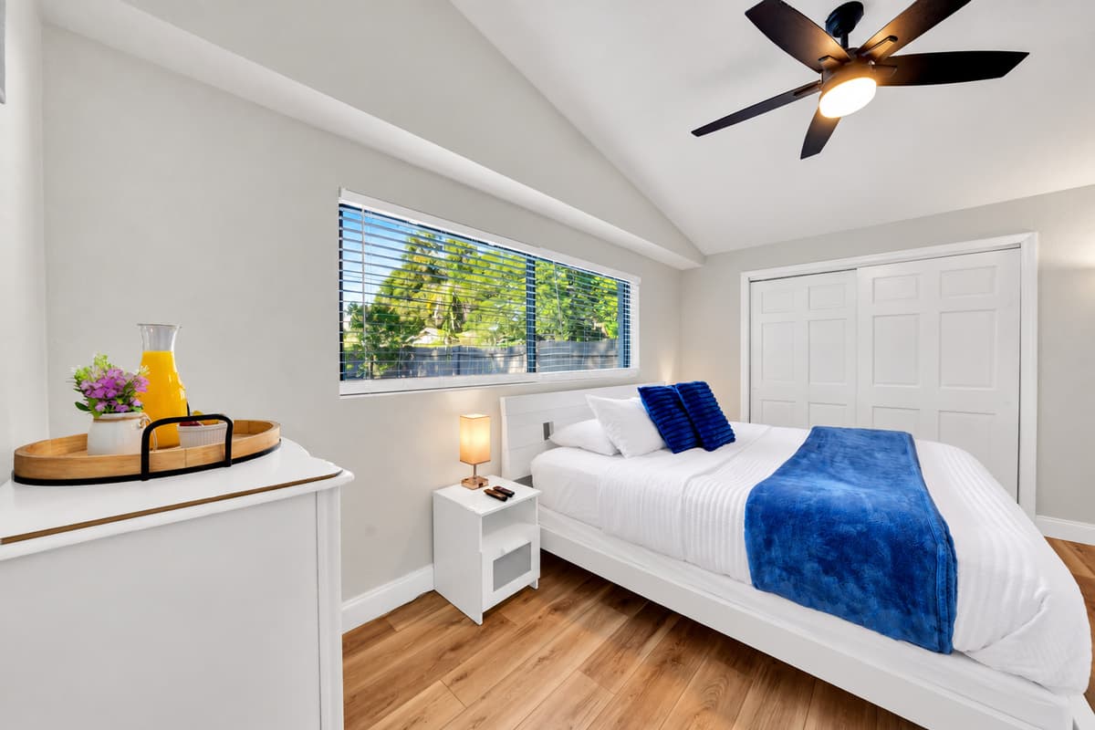 There's real floor space in here, not just a bed wedged between two walls. Room to open both suitcases, room to walk around the bed at 6 AM without waking anyone, and a closet big enough to make it worth unpacking.