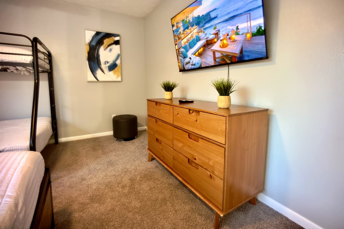 A well-appointed space featuring a queen-size bed and a bunk bed, perfect for a good night's sleep after a day of fun.