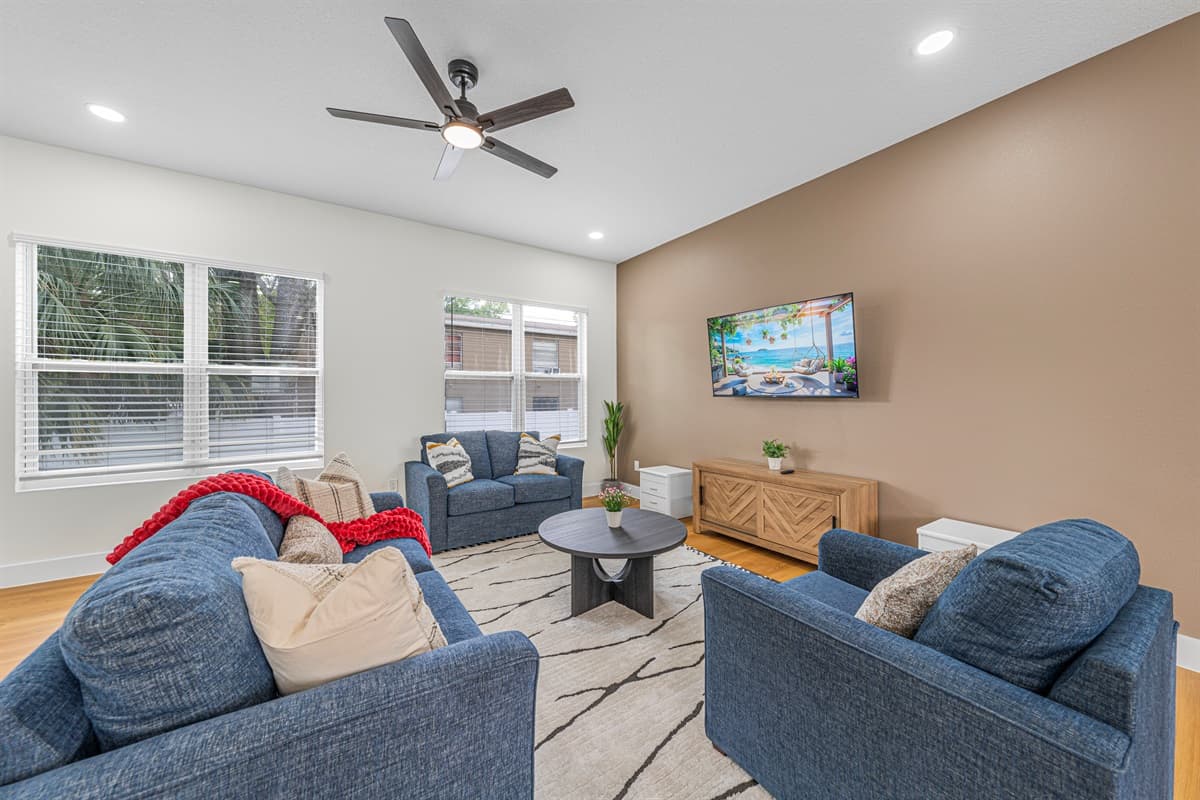 Comfortable living room with plush seating, natural light, and entertainment setup.