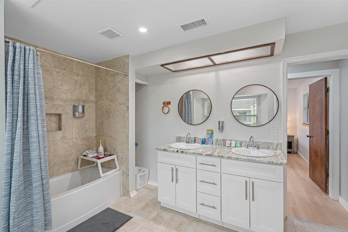 The centerpiece of the space is the inviting tub and shower combination, offering the best of both worlds.