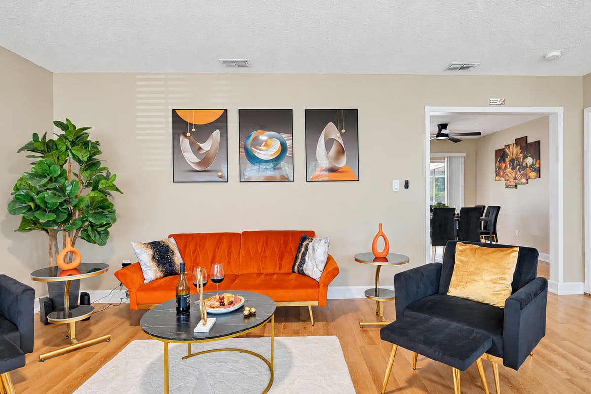 Feel the allure of our sumptuous, oversized sofas and armchairs, elegantly adorned in a captivating blend of vivid orange and deep navy blue, injecting a burst of vitality into the room.
