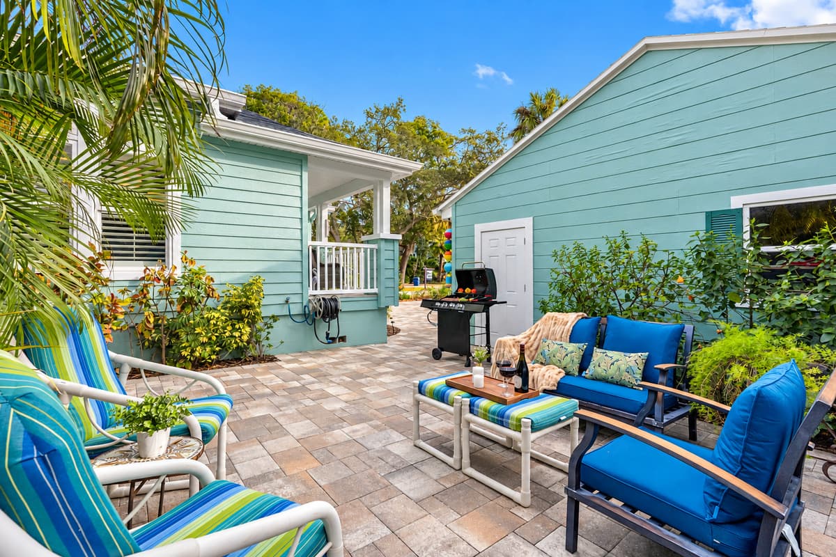 Tucked beside beautiful palms, this outdoor seating nook provides a peaceful retreat with natural privacy.