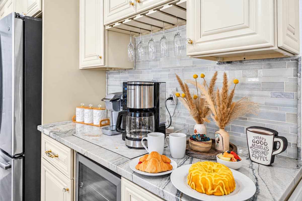 Start your mornings at this charming coffee station, thoughtfully set up with a coffee maker, mugs, and a cozy countertop space to ease into the day.