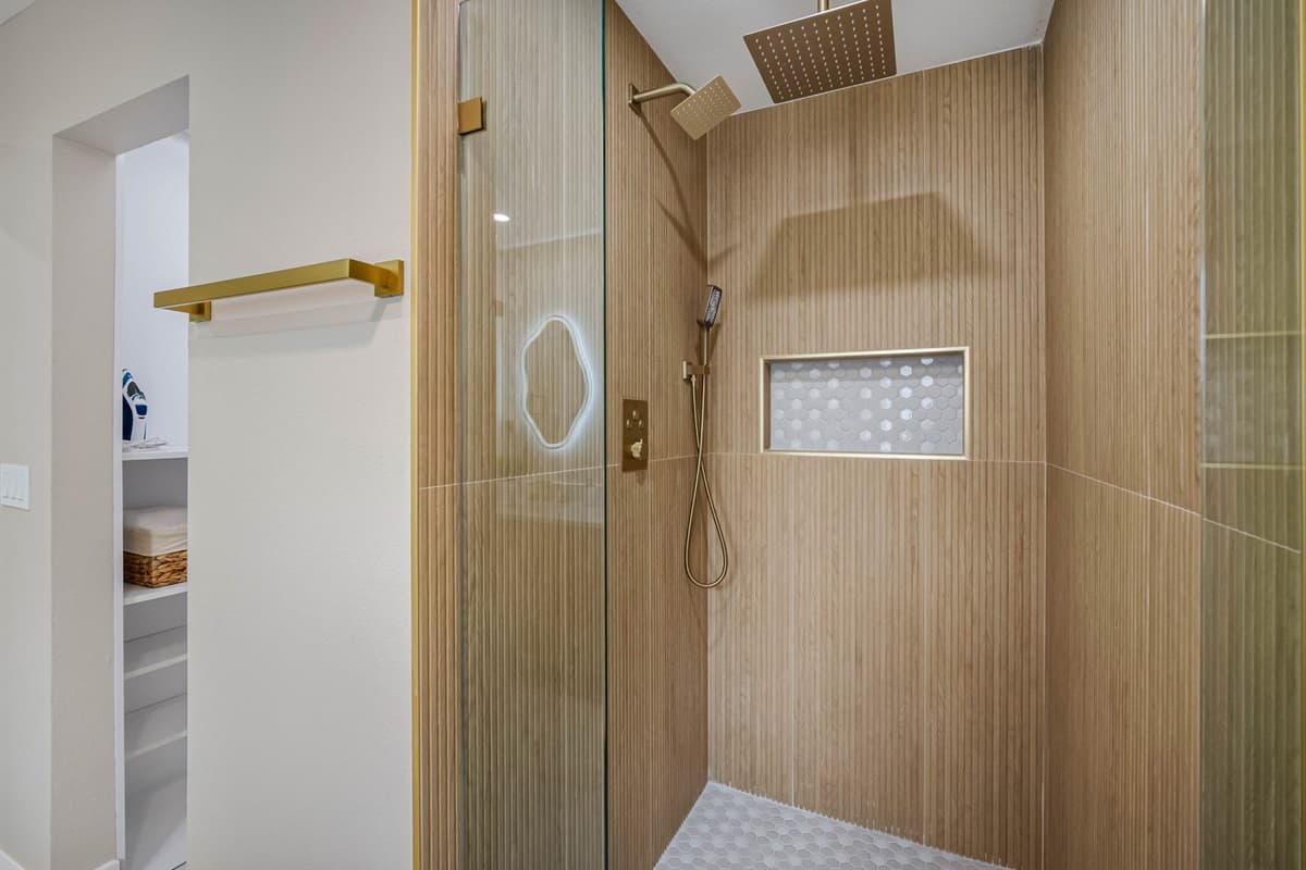 The combination of soft tones, high-end fixtures, and designer lighting creates a calming environment that feels like a boutique hotel.