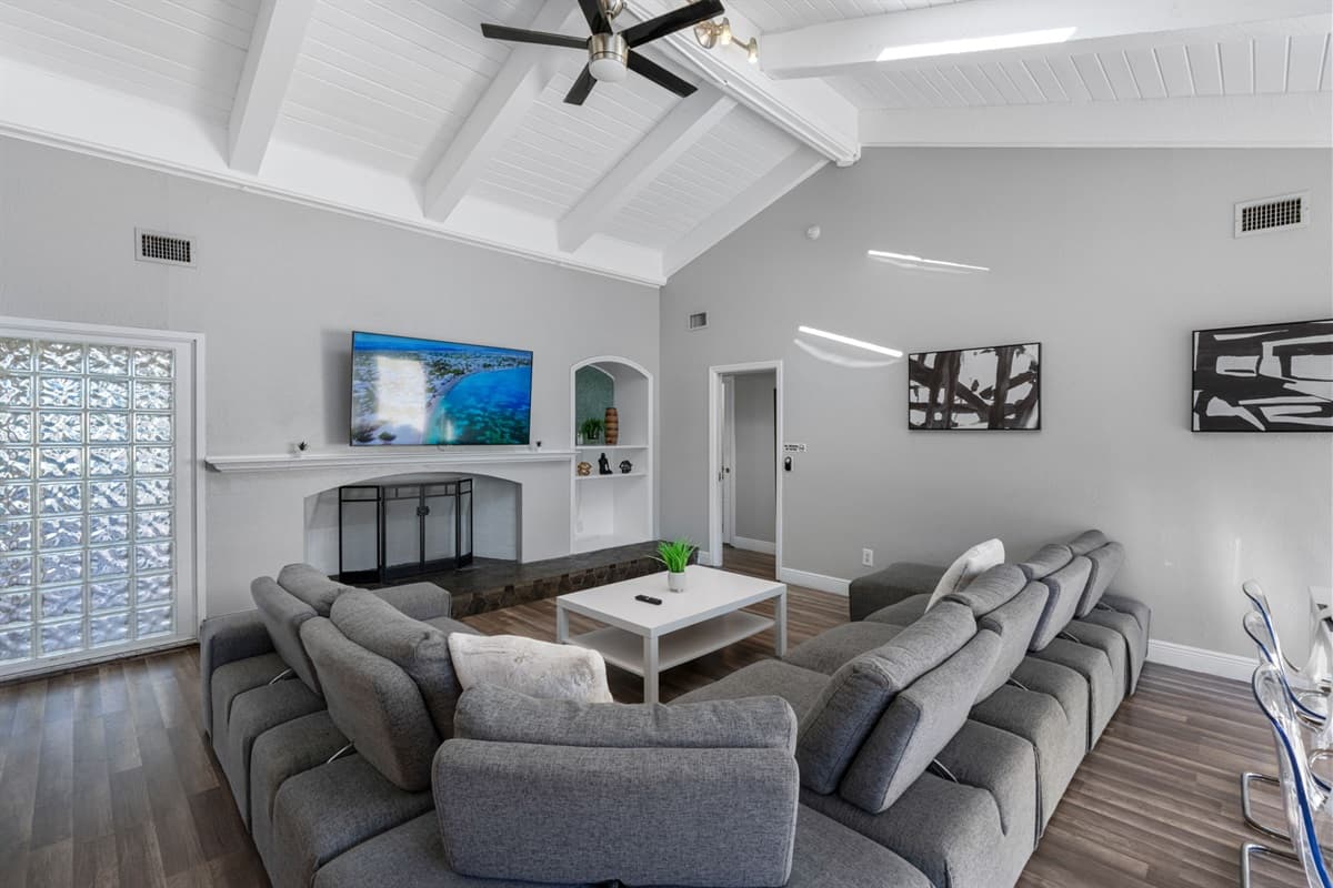 Cozy up on the oversized sofa and enjoy your favorite shows on the large flat-screen TV in this inviting, open-concept living room.