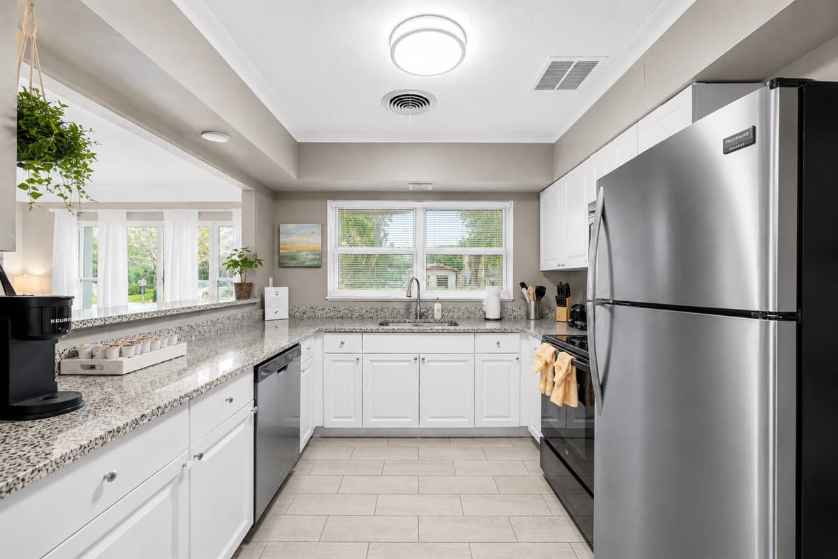 Fully equipped kitchen with stainless steel appliances and an open, airy layout.