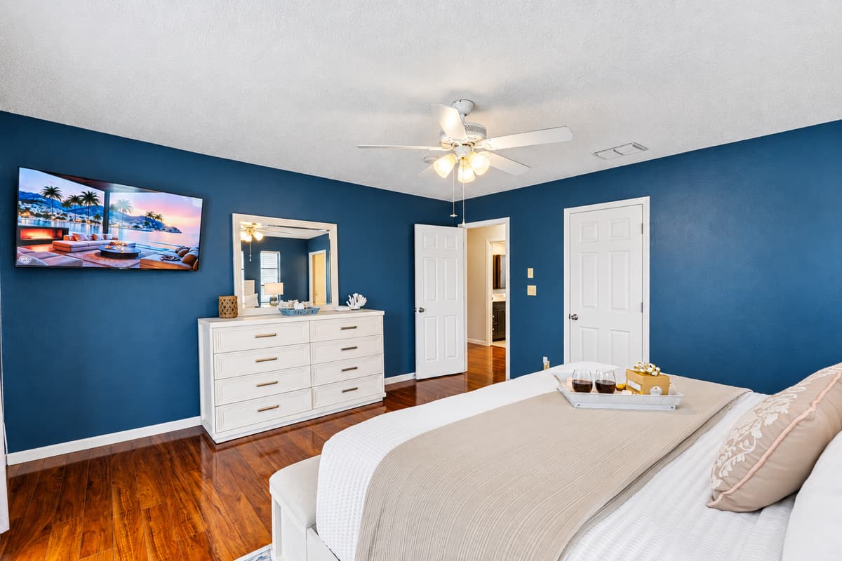 The deep navy accent walls create a rich, moody atmosphere that feels both calming and sophisticated.
