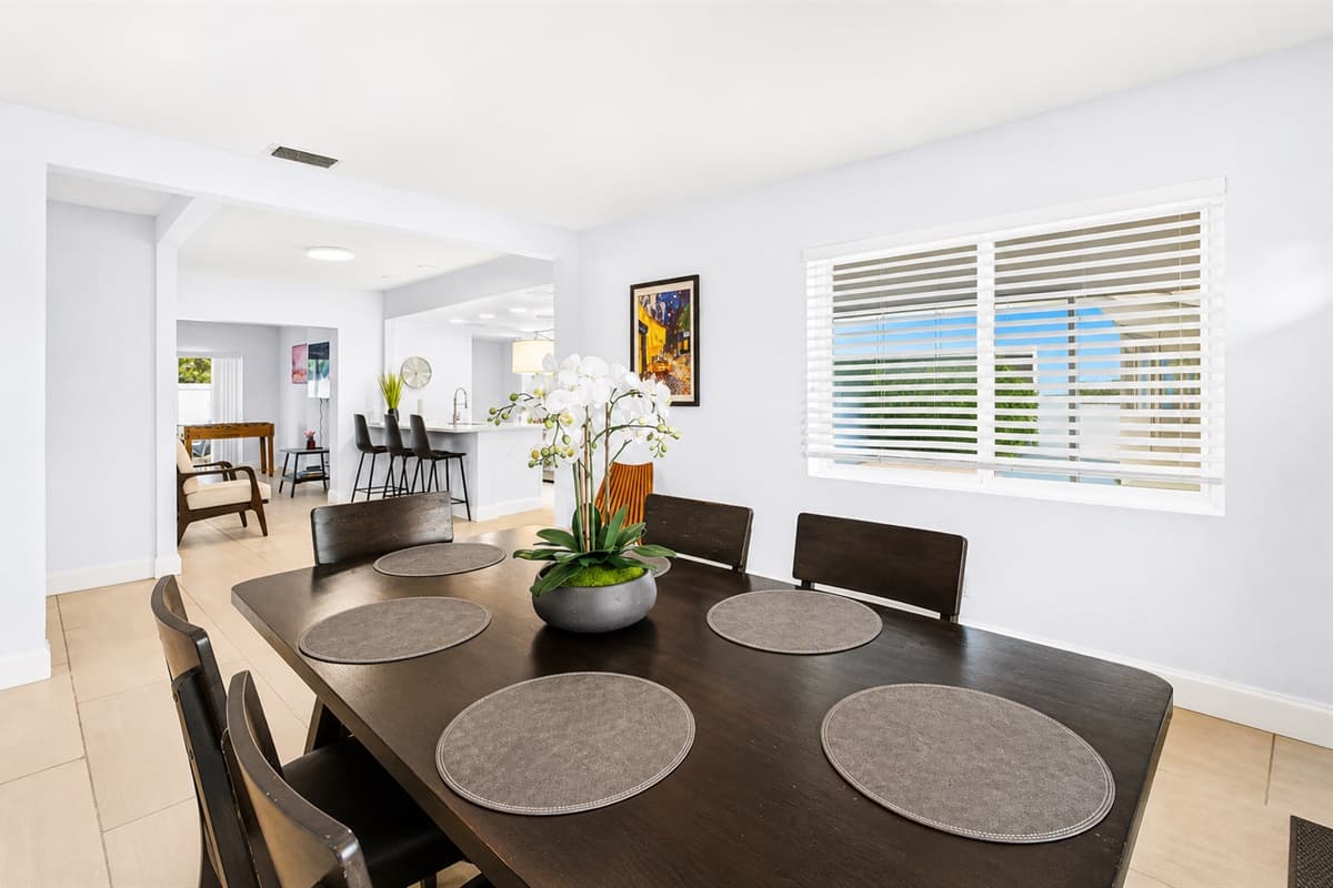 Spacious dining room with large windows, ample seating, and a welcoming atmosphere for gatherings.
