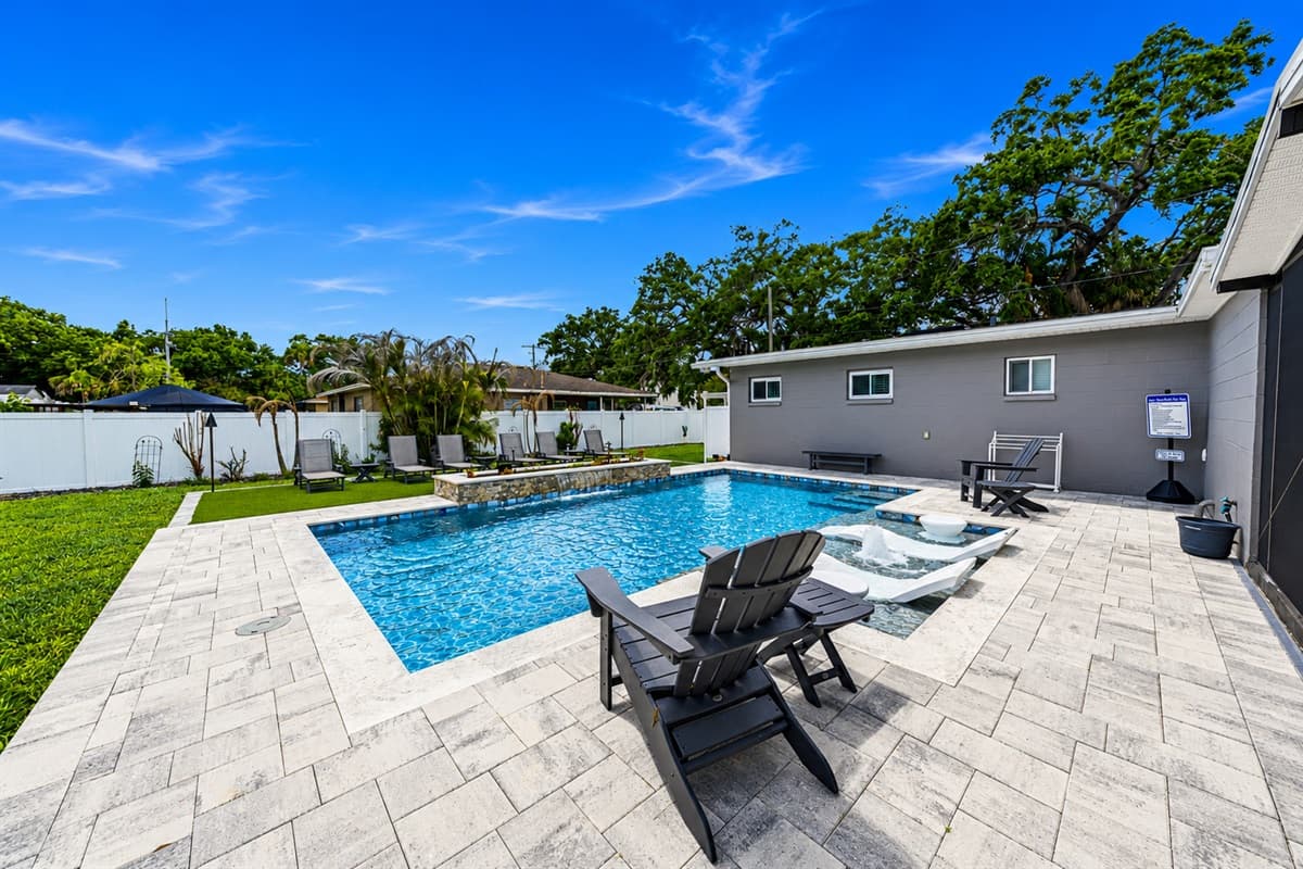 Bright backyard pool oasis featuring expansive patio space and plenty of room to relax under the Florida sun.