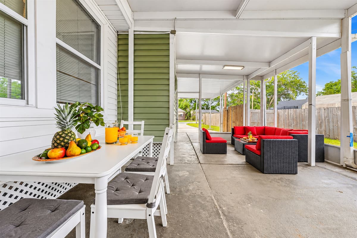 Covered outdoor lounge with dining table and seating—perfect for relaxing or enjoying meals outside.