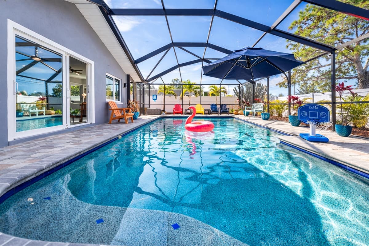 Spacious private pool with a fun flamingo float and comfortable outdoor seating.