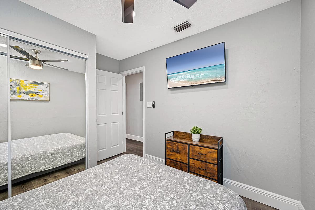 Comfortable bedroom with queen sized bed, smart TV and full sized mirror closet. Sleep safe and sound on the comfort of your home away from home. If you have any questions, send us a message!