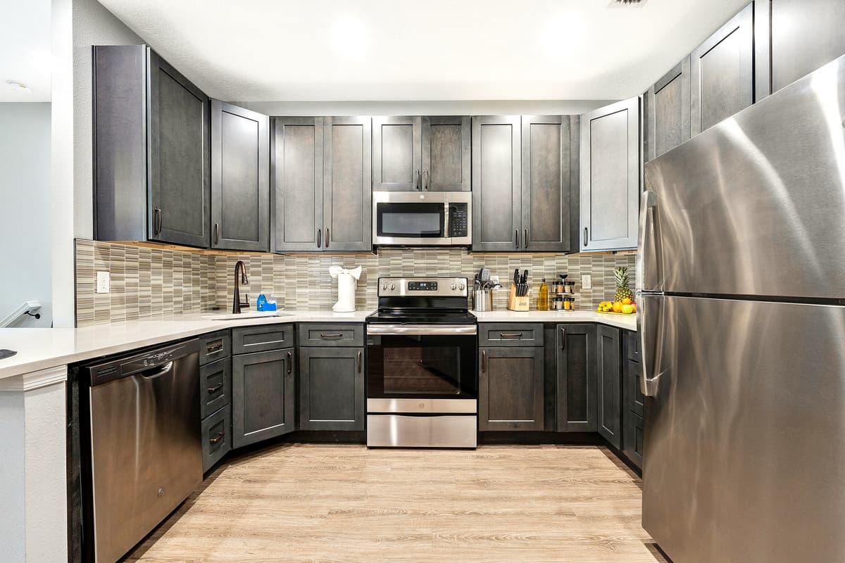 Natural light floods the space through strategically placed windows, creating a bright and inviting atmosphere that adds to the overall warmth of the kitchen.