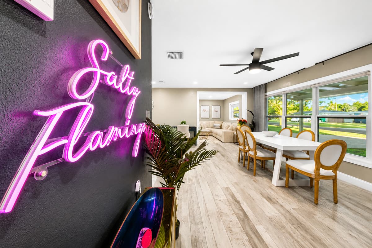 Close-up of the custom "Salty Flamingo" neon sign, creating a fun and memorable vacation-home atmosphere.