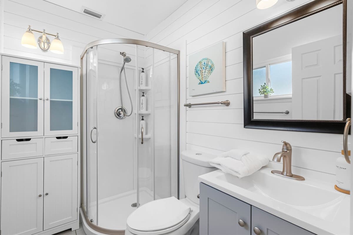 A glass-enclosed shower and modern vanity make this bathroom a relaxing escape.