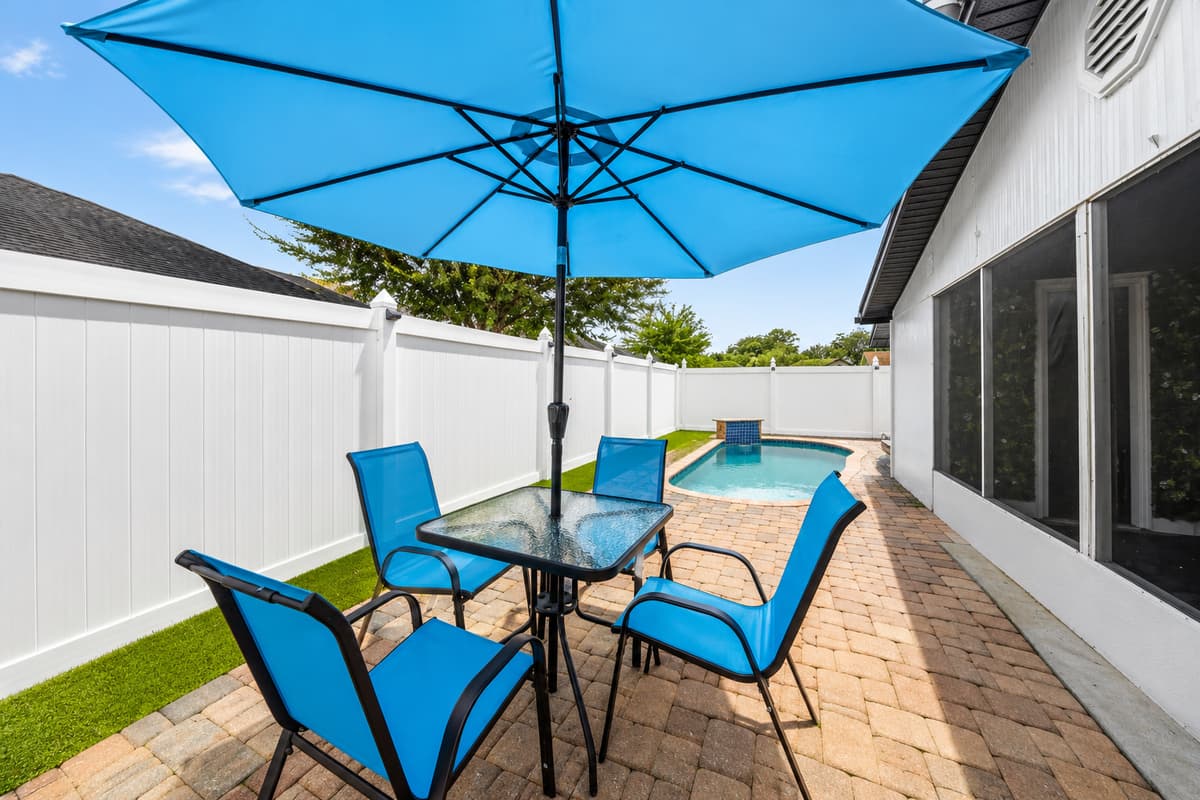 Outdoor dining area beside the pool, perfect for morning coffee, al fresco meals, and enjoying Tampa's beautiful weather.