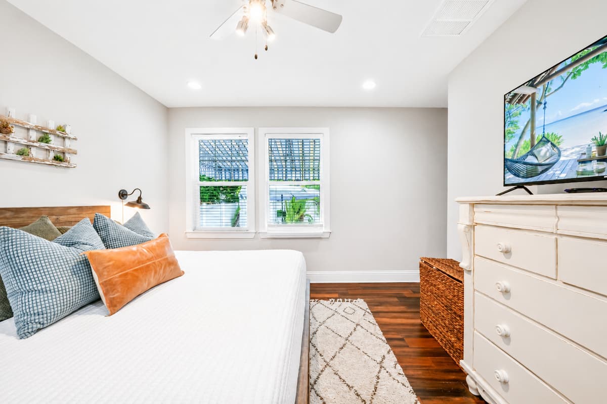 Wake up refreshed in this bright and inviting bedroom with a king bed, dresser, and plenty of natural light.