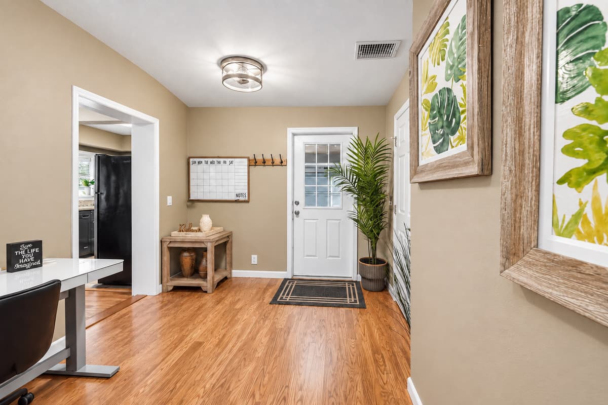Welcoming entryway with stylish décor and a dedicated workspace nook.