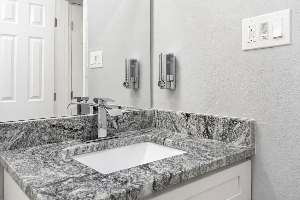 Our impeccable bathroom with toilet, sink and walk in shower. Feel fresh and clean after a long day of travel from your home to your home away from home. If you are interested in this property, send us an inquiry now!