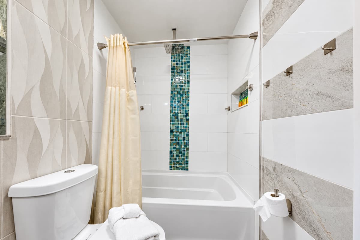 Designed for comfort and convenience, this bathroom features a tub/shower combo and elegant finishes.