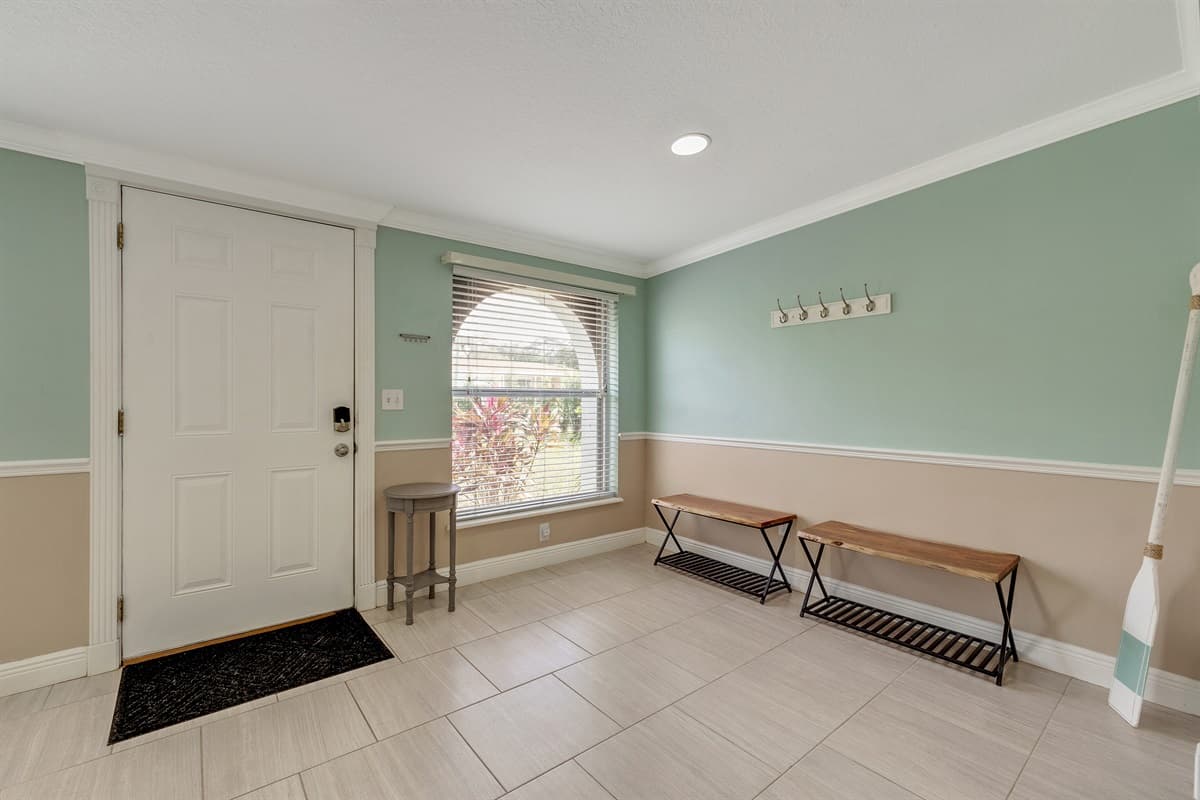 Discover an additional seating area just beyond the front door, creating a welcoming space that sets the tone for your entire stay.