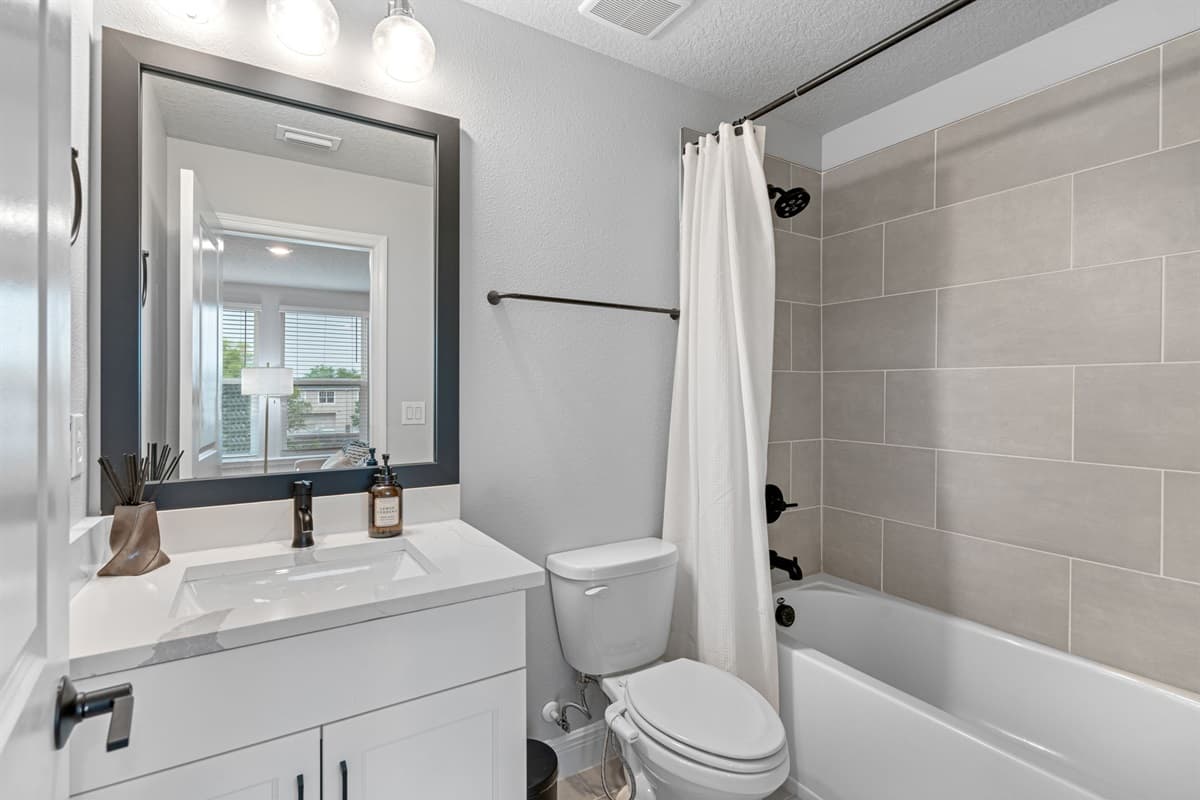 A sanctuary of modern design, featuring sleek fixtures, clean lines, and tasteful accents that elevate the space to new heights of sophistication.