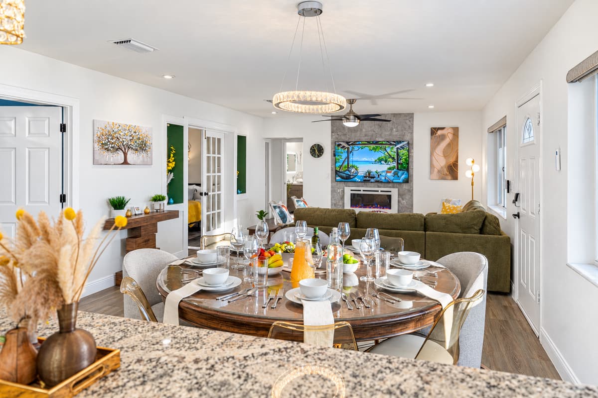 A bright and elegant dining area designed for memorable meals, featuring a spacious table, stylish seating, and beautiful lighting overhead.