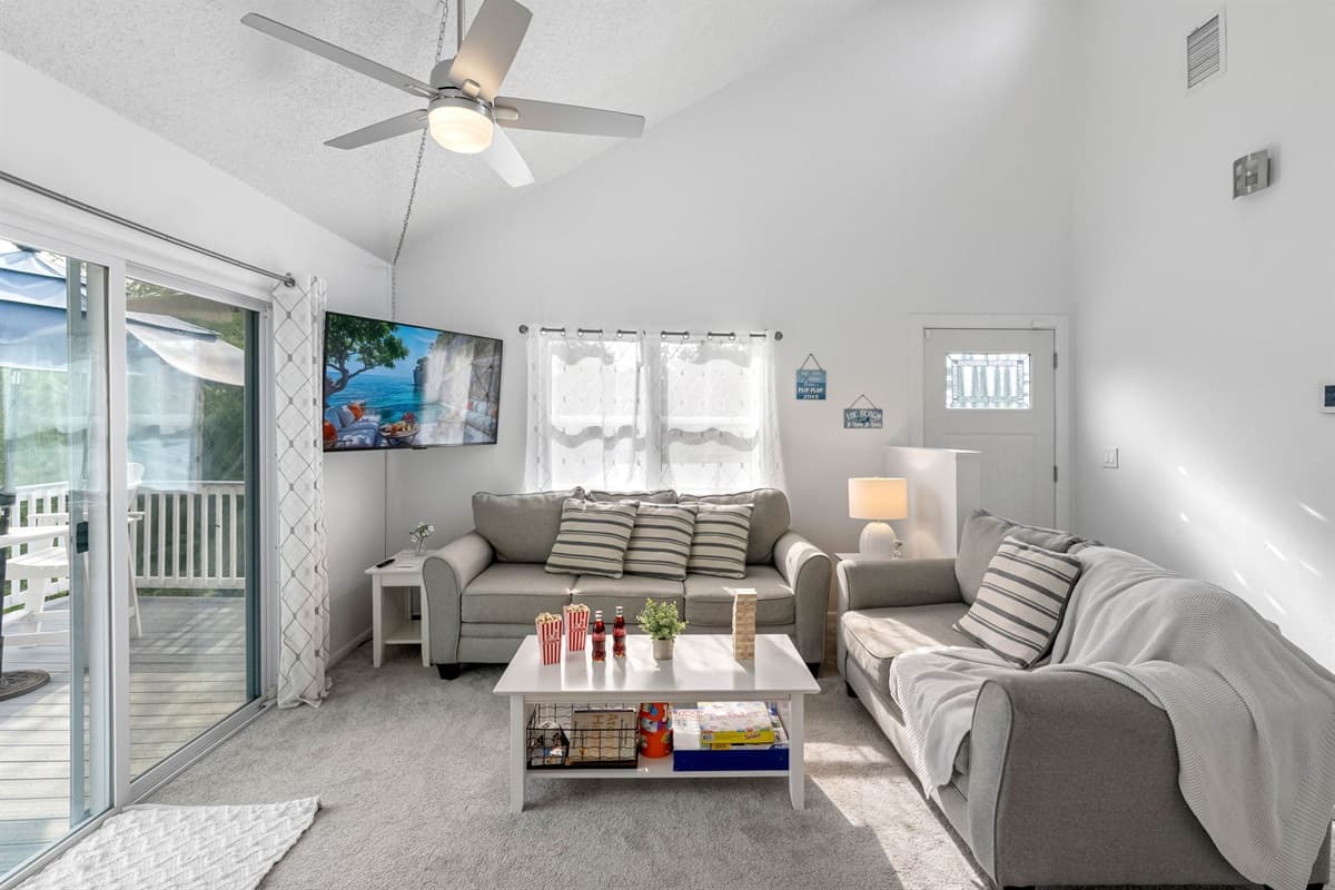 This living area combines modern furnishings with beachy charm, offering a serene retreat after a day of exploring Crystal Beach.