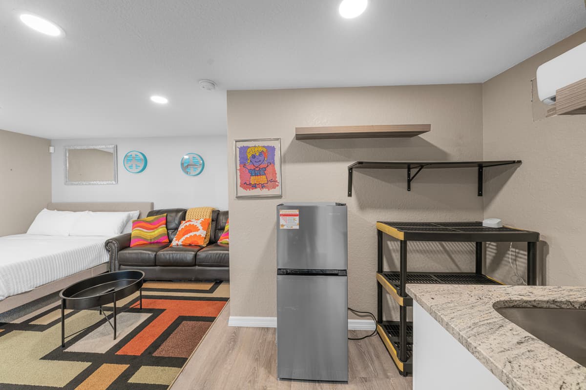 Bright and inviting living room with plush sectional seating, stylish décor, and plenty of space to relax. — photo 49