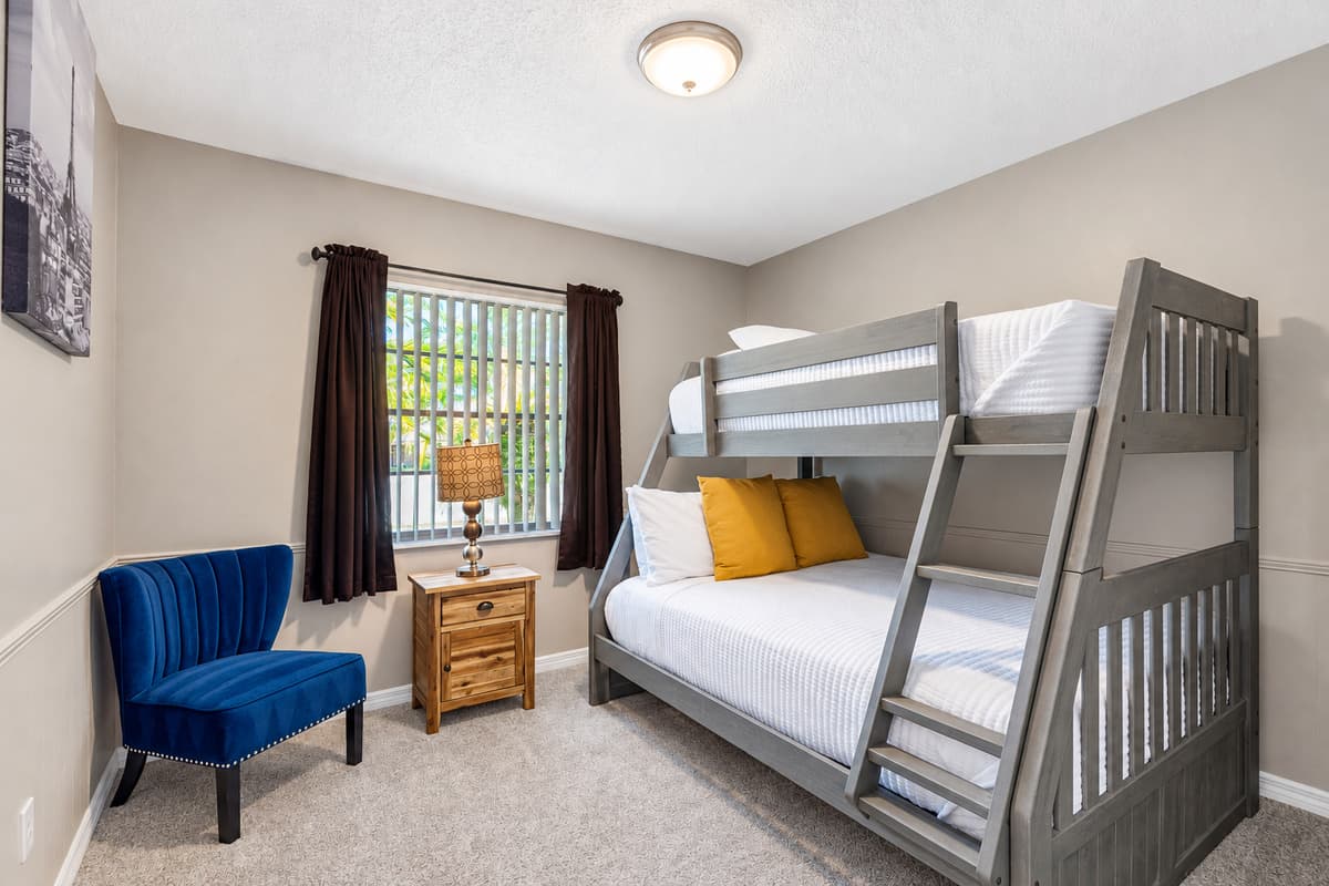 This cozy bedroom features a twin-over-full bunk bed, perfect for accommodating both kids and guests in comfort.