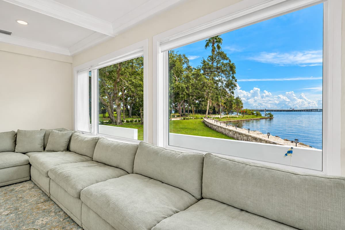 A sectional with a bay view. The huge sectional faces windows that look straight onto the lawn, seawall and water. The best nap spot in the house.
