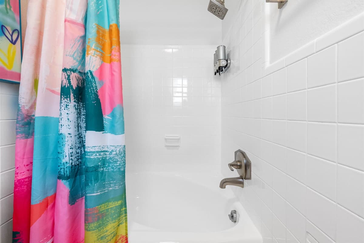 A rain shower and a deep soaking tub offer a rejuvenating retreat after a day of exploring the lively streets of Miami.