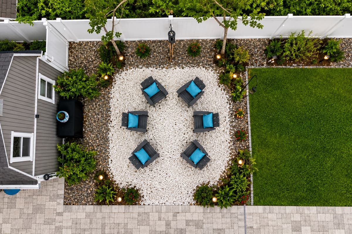 Aerial top-down view of the charming outdoor lounge gathering area and spacious backyard layout.